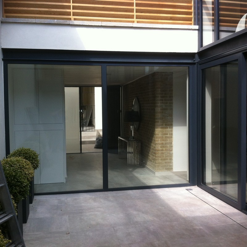 Floor-to-ceiling sliding doors opening to courtyard in Ascot