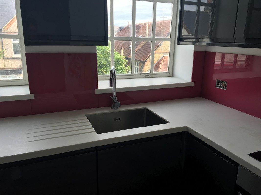 Deep plum coloured glass splashback in modern Ascot kitchen
